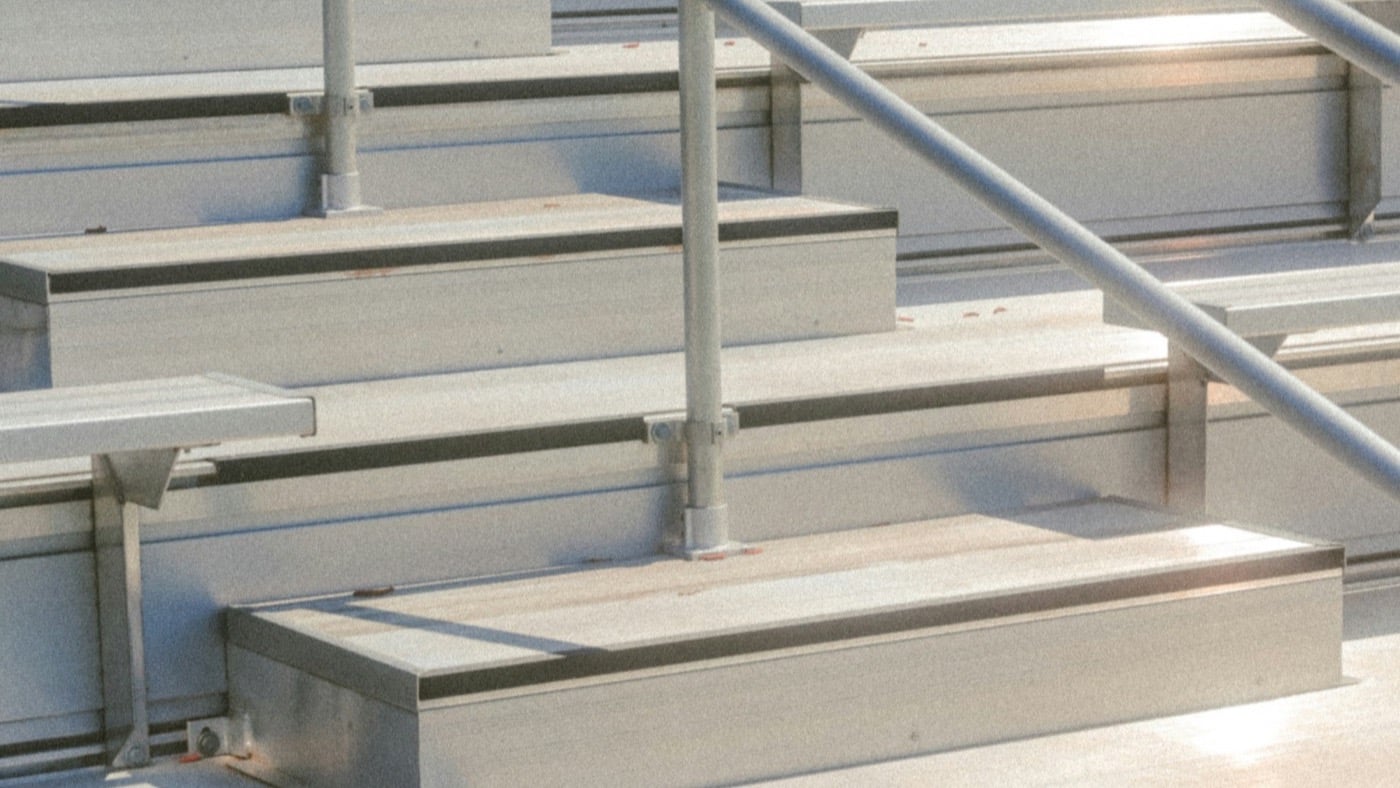 Empty aluminium bleachers at a school athletic facility